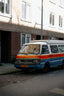 A colorful van is parked on a city street.