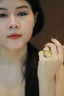 woman holding gold ring on her left hand