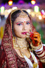 Bride in traditional indian wedding attire and jewelry.