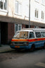 A colorful van is parked on a city street.