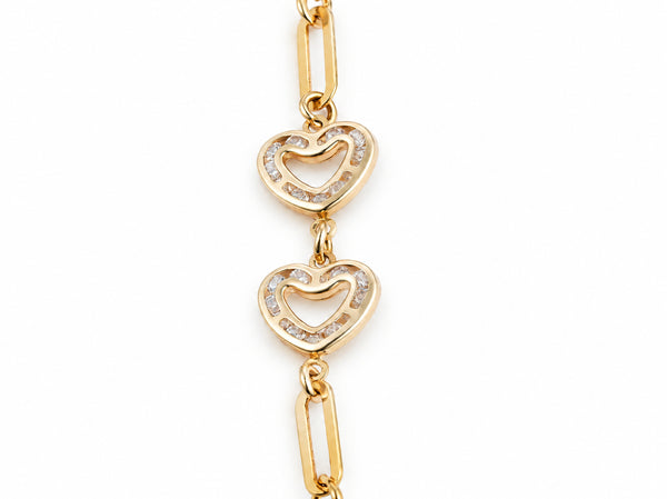 Close-up of two open heart links set with small cubic zirconia stones