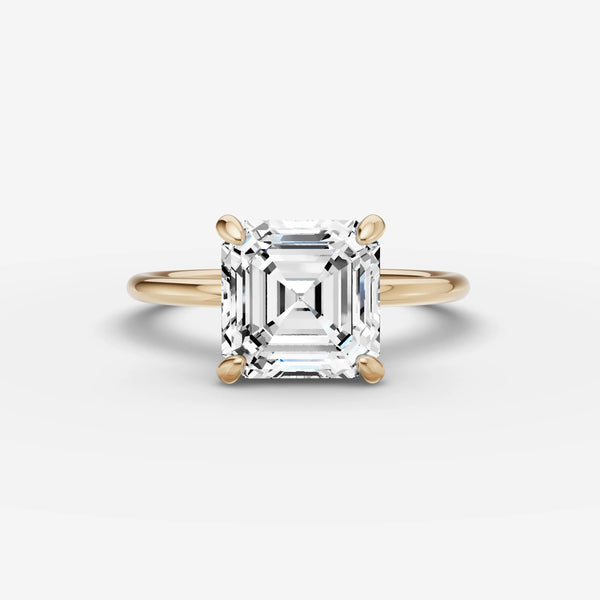 Front view of solitaire ring setting holding square step-cut stone in yellow gold