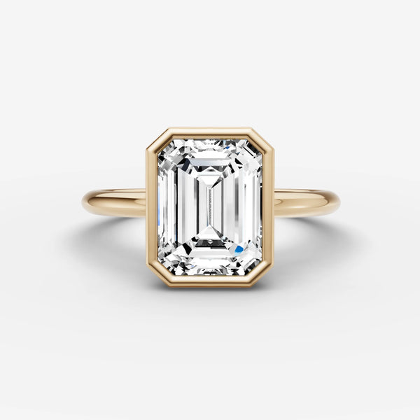 Yellow gold bezel engagement ring setting with emerald-cut center stone, front view