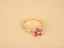 Gold ruby flower ring featuring marquise-cut rubies and diamond cluster in Blooming Elegance style