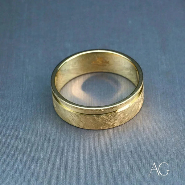 Elegant 18k gold diamond wedding band with textured gold and polished rim