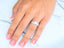 Elegant white 18k gold wedding band on hand with French-tipped nails, showcasing art gold jewelry