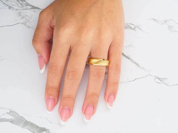 Radiant Horizon polished gold band ring on French manicured finger