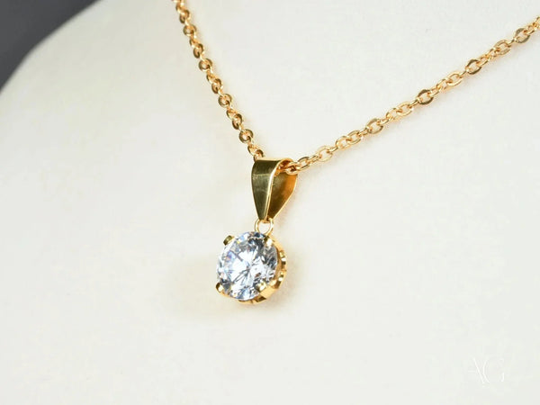 Radiant solitaire pendant in art gold jewelry with round-cut diamond