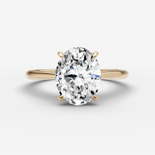 Front view of oval solitaire cathedral engagement ring setting in yellow gold