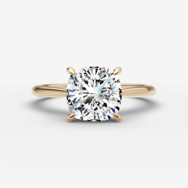 Front view of cushion-cut solitaire cathedral ring in yellow gold with four-prong setting