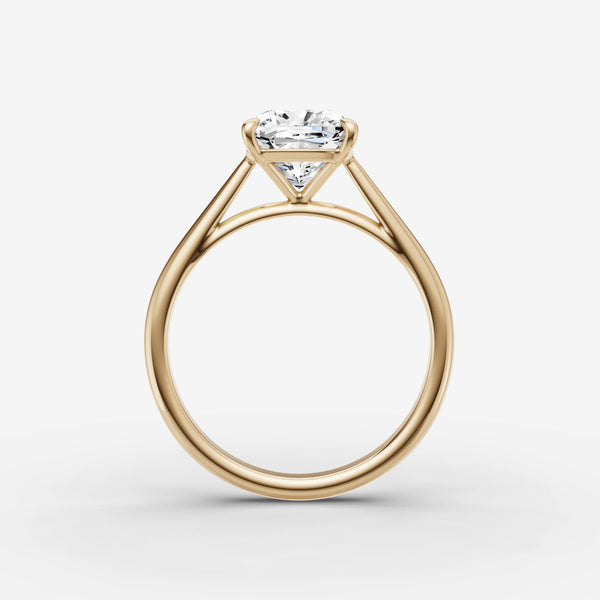 Side view of cathedral solitaire ring in yellow gold showing arched shoulders