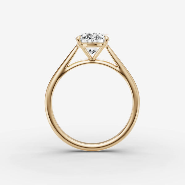 Side profile view of oval solitaire cathedral engagement ring setting in yellow gold