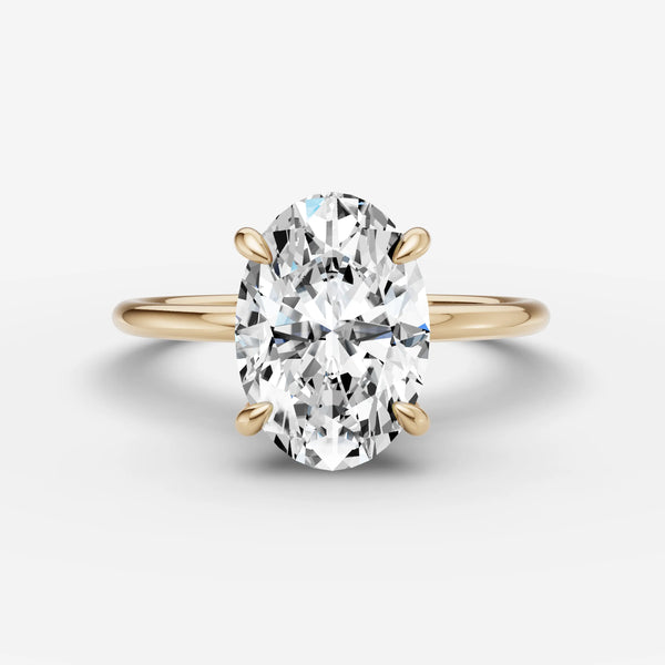 Yellow gold oval solitaire engagement ring setting, front view with four prongs