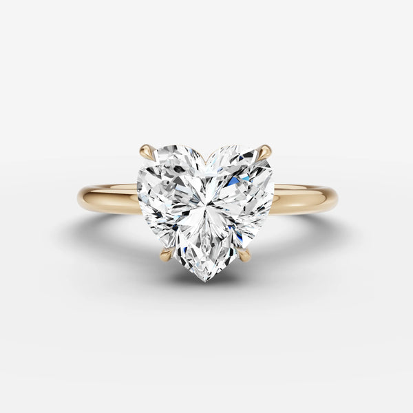 Heart-cut solitaire engagement ring setting in yellow gold, front view