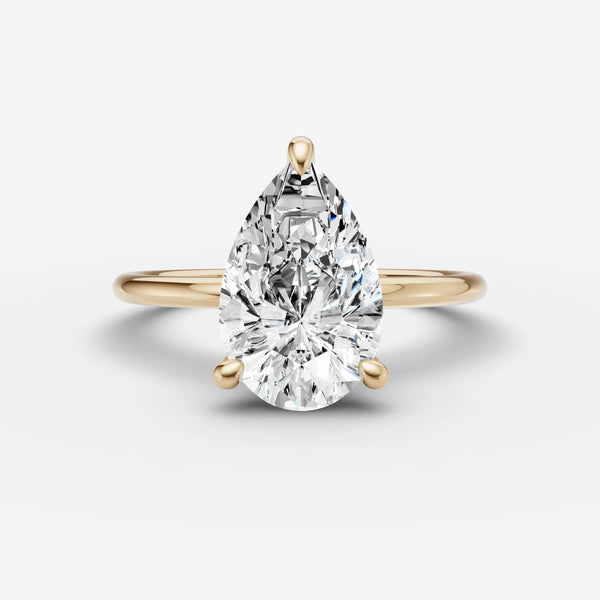 Solène Pear solitaire ring setting shown at an angle, highlighting the pear-cut center mount