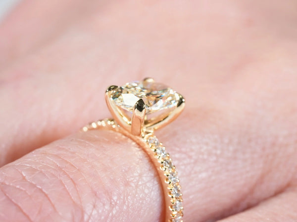 Side view of Soleil Pavé oval diamond ring showing the raised center-stone setting