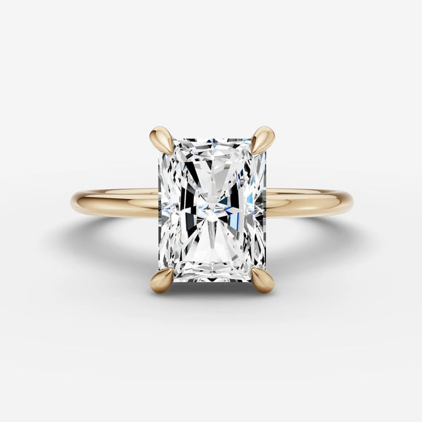 Solitaire engagement ring setting with radiant-cut stone, yellow gold band, front view