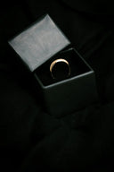 Sleek 14k gold wedding band in black gift box, art gold jewelry style