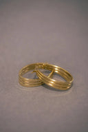 a couple of gold rings sitting on top of a table