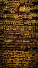 a wall covered in lots of gold jewelry