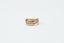 gold and black ring on white surface