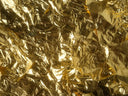 Close-up of crumpled gold foil reflecting light
