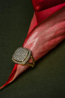 Gold-toned 18k gold ring with square pave-set diamond face and twisted band featured in gold jewelry comparison.