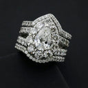 A dazzling pear-shaped diamond ring in platinum with pave-set stones showcasing fine jewelry and art gold trends
