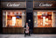 man playing cello in front of store