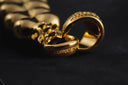 Gold-toned 18k gold jewelry chain with textured interlocking links and coppertist engraving in fine jewelry design