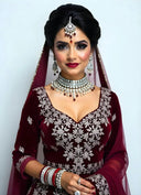A woman wearing a red and white outfit and jewelry