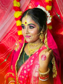 Bride posing with elaborate makeup and jewelry.