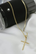 Gold cross pendant with subtle diamond accents on a delicate chain crafted in 18k gold highlighting art gold jewelry in everett
