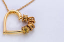Gold heart-shaped pendant necklace with engraved name beads showcasing custom jewelry at Everett jewelry store.