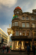 Art deco Rolex building with gold clock tower and red dome