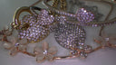 A sparkling gold heart pendant with clear crystals and floral charms exemplifying 18k gold art deco jewelry.