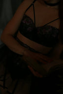 a woman in a bra top reading a book