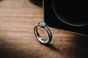 a diamond ring sitting on top of a wooden table