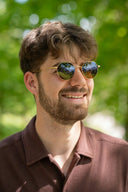 David Yurman art gold jewelry: gold-rimmed round sunglasses with mirrored lenses