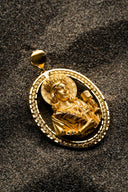 Golden oval pendant featuring a detailed relief of a crowned figure is a fine example of art gold jewelry.