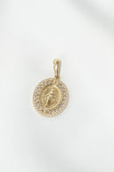 Gold-toned art gold jewelry pendant featuring a detailed religious figure encircled by sparkling clear stones.