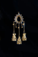 Gold-plated jhumka earrings with intricate filigree work and blue gemstones exemplify art gold jewelry traditions