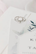 a couple of wedding rings sitting on top of a table