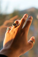 person wearing silver and black ring