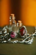 a close up of a pair of earrings on a table