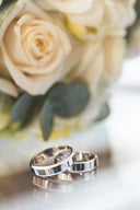 Two silver-toned polished wedding bands reflecting fine jewelry elegance in his-and-her gold jewelry pairings