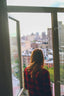 woman in red jacket looking at the city during daytime