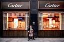 Man playing cello before Cartier store in luxury jewelry art scene