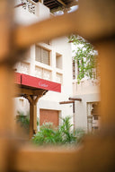 Red cartier awning with white lettering featured in article comparing 18k gold jewelry and brands like van cleef and harry winston