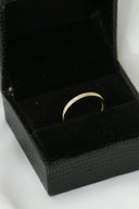 Delicate 18k gold band ring with sparkling diamonds, birthstone jewelry